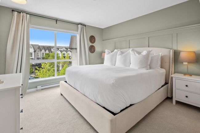 Bedroom featuring light carpet and baseboard heating | Image 21