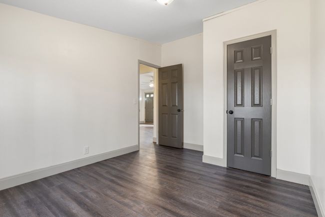 The third bedroom is a cozy and inviting space with a serene view of the wooded backyard. Whether used as a bedroom, home office, or guest room, this peaceful retreat offers both comfort and versatility. | Image 11