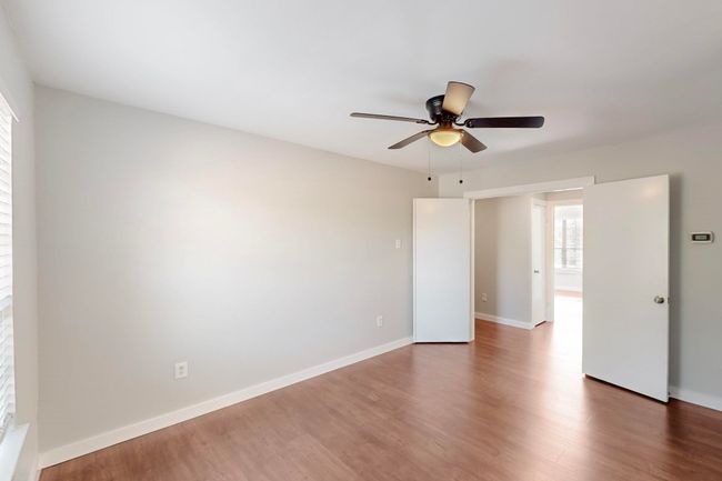 Spare room featuring baseboards, wood finished floors, and ceiling fan | Image 21