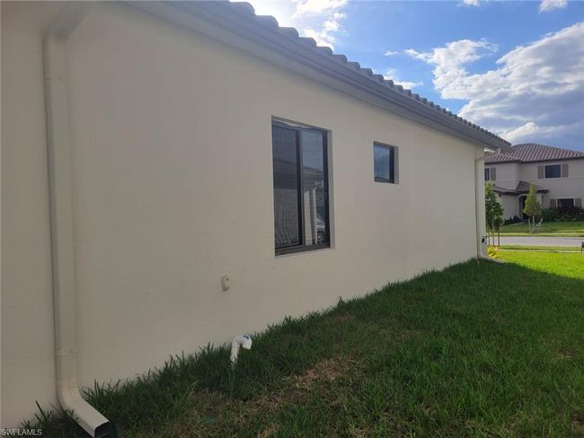 View of side of home featuring a lawn and stucco siding | Image 32