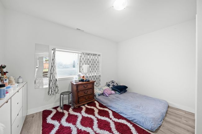 Bedroom with baseboards, visible vents, and light wood-style flooring | Image 21