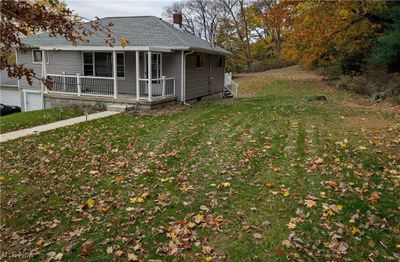 View of front of house with a front lawn, covered porch, and a garage | Image 3