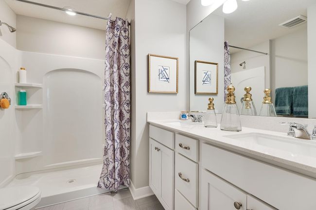 In addition to the space provided in the primary bedroom, the attached bath provides a true oasis to come home to, featuring a double vanity and stand-in shower. Photo of model, colors and options will vary. | Image 14