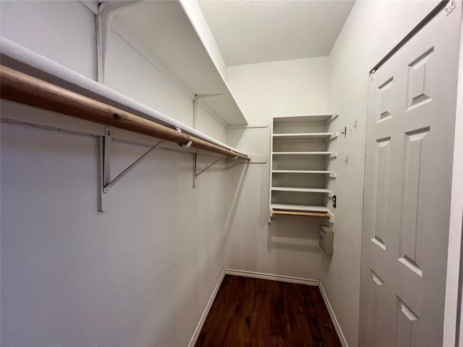 Spacious closet with wood finished floors | Image 10