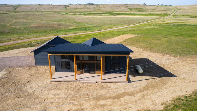 Back of house featuring a view of rural / pastoral area, a metal roof, and board and batten siding | Image 6