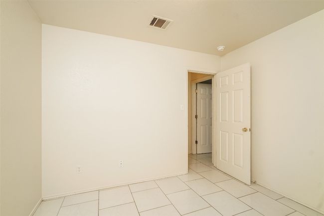 Spare room featuring a smoke detector and light tile patterned floors | Image 16