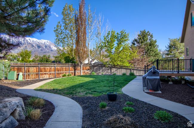 View of yard featuring a fenced backyard and a deck with mountain view | Image 42