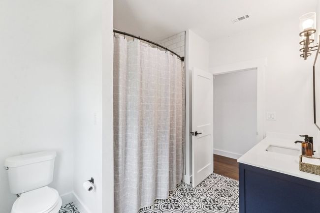 Bathroom featuring vanity and a shower with shower curtain | Image 27