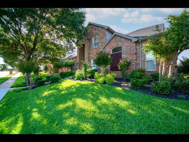 View of front of house with brick siding and a front yard | Image 4