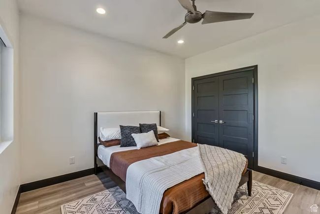 Bedroom featuring a closet, recessed lighting, light wood-style flooring, and baseboards | Image 57