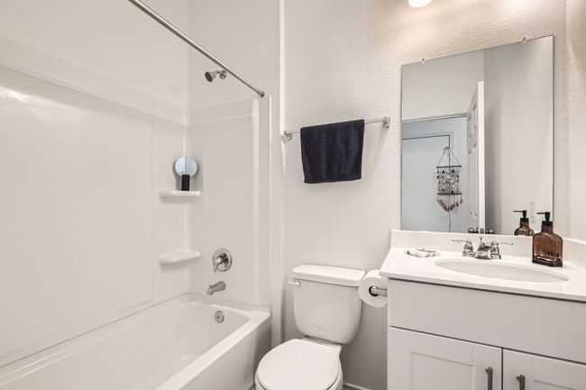 Bathroom with vanity, toilet, and shower / washtub combination | Image 23
