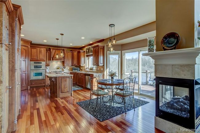 Welcome to your gourmet kitchen with brazilian cherry hardwood floors, breakfast nook and gas fireplace | Image 15