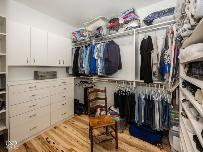 spacious closet with light wood-style floors | Image 24