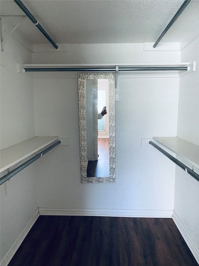 Walk in closet with dark wood-type flooring | Image 6