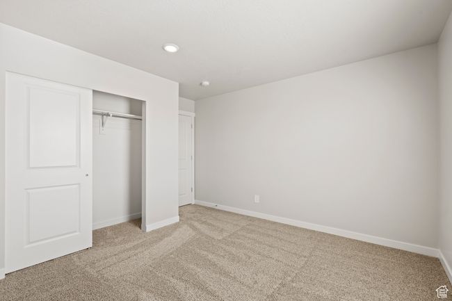 Unfurnished bedroom with carpet floors, a closet, baseboards, and recessed lighting | Image 41