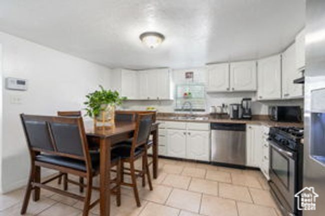 Kitchen featuring white cabinets, stainless steel appliances, and a sink | Image 12