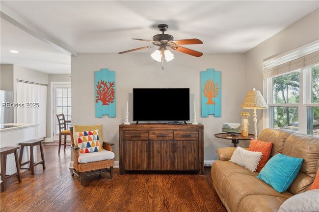 Primary living room with hardwood floors, ample seating, bright natural lighting, smooth ceilings. | Image 36