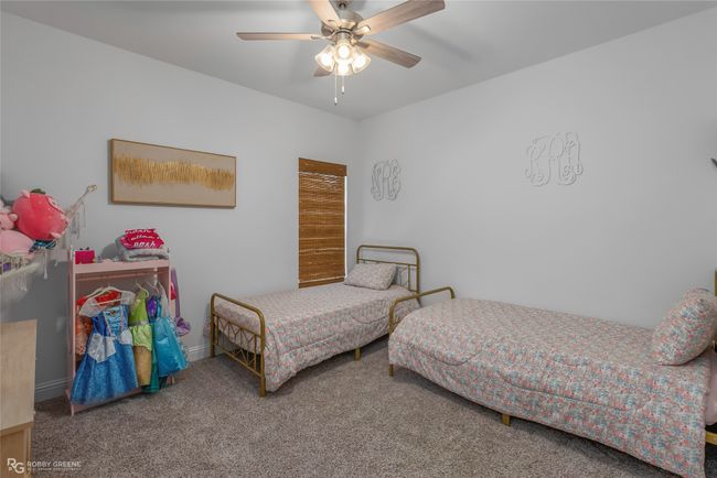 Carpeted bedroom with baseboards and a ceiling fan | Image 20