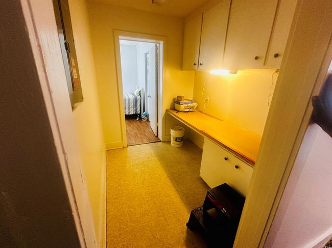Hallway featuring light floors and an office area | Image 8
