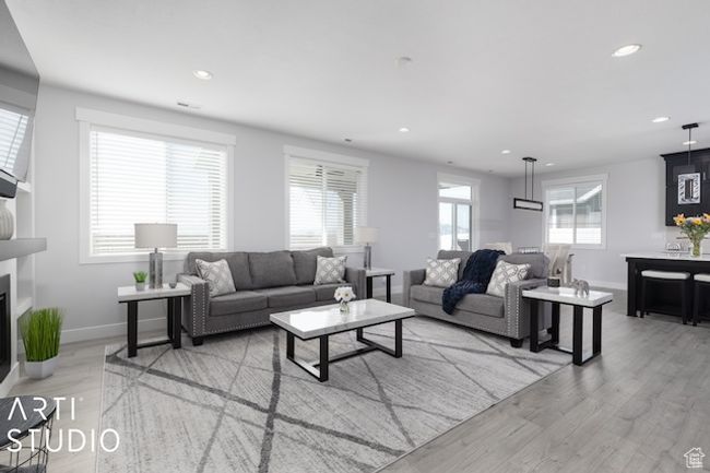 Living area featuring light wood finished floors, recessed lighting, and baseboards | Image 19