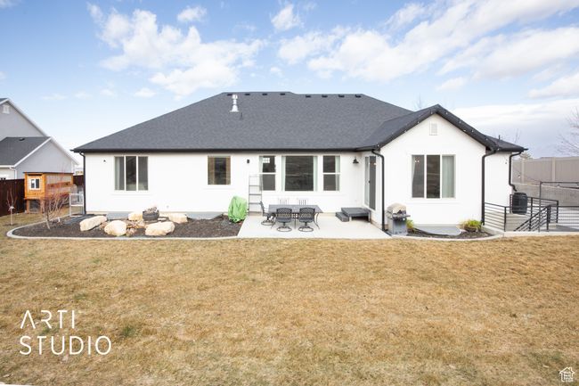 Rear view of property with a patio area and a lawn | Image 46