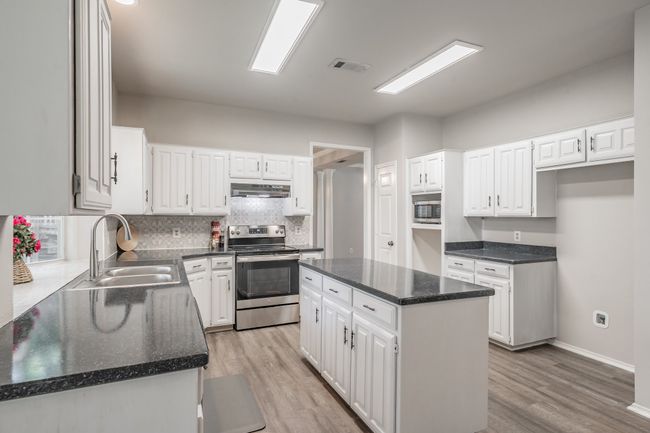 Kitchen featuring stainless steel appliances and an island offering additional prep space! | Image 12