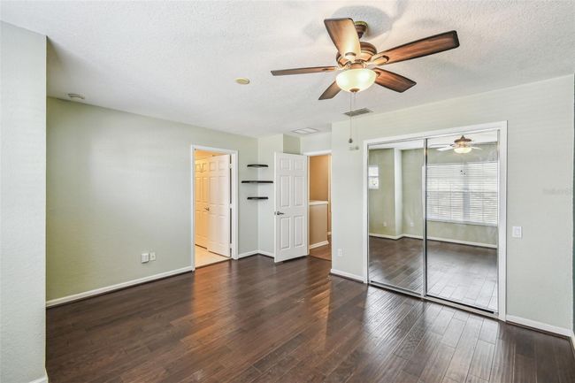 Upstairs primary bedroom features an en-suite, updated bathroom complete with a double vanity, garden tub, walk-in shower, and a private toilet closet. | Image 15