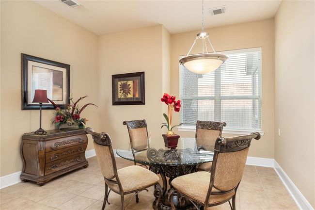 Flooded with natural light and offering plenty of room to spread out, the breakfast room is both inviting and versatile. Tile floors add a clean, polished touch, while the generous layout easily accommodates a buffet table or china cabinet—perfect for casual meals or weekend brunches with family and friends. | Image 11