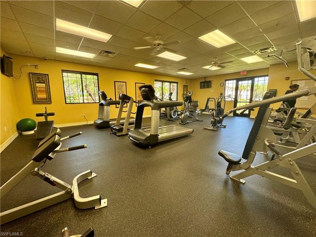 Exercise room featuring visible vents, ceiling fan, a paneled ceiling, and baseboards | Image 37