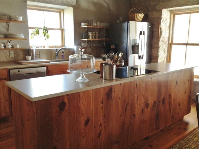 Kitchen features an induction cooktop and convection oven. | Image 6