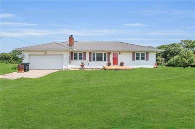 Single story home with a garage and a front yard | Image 1