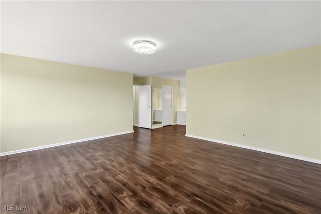Empty room with dark wood finished floors and baseboards | Image 23