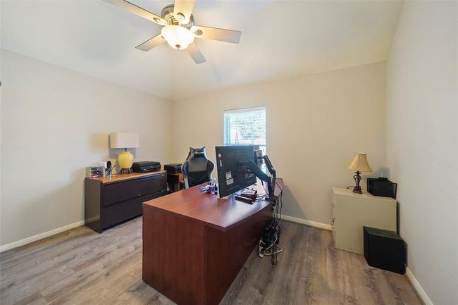 Another secondary bedroom being used as an office. | Image 23