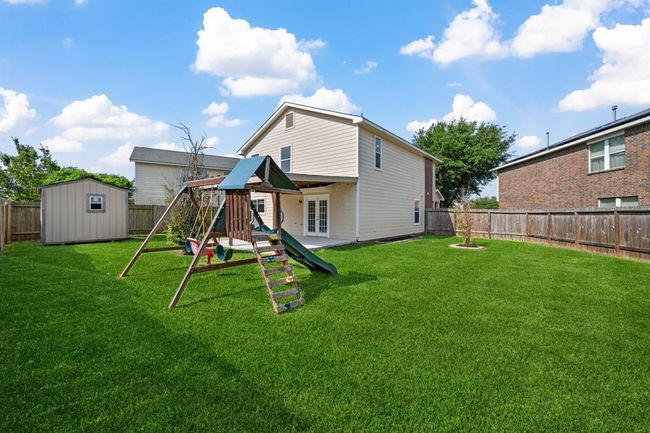 Another view of the large backyard with play space and open sky. | Image 5