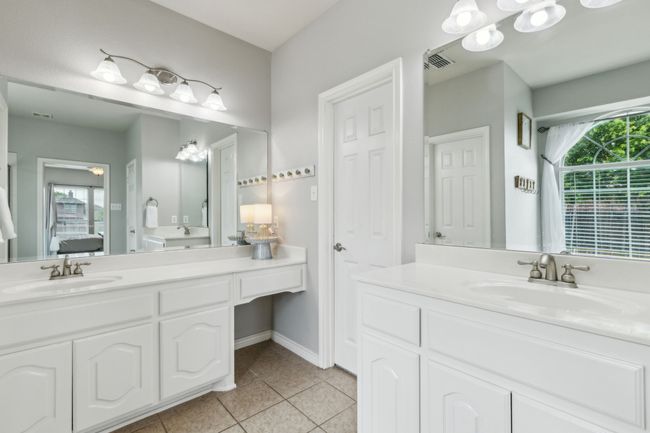 Primary ensuite bathroom with a garden tub, tile flooring, separate shower, and two vanities | Image 20