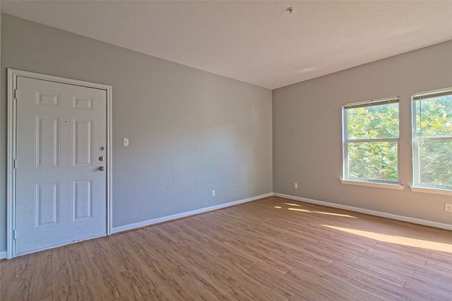 Unfurnished room with wood finished floors and fire sprinkler in ceiling | Image 10