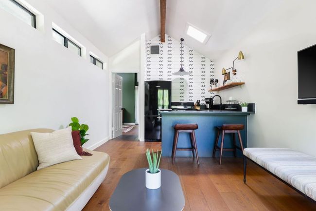 Living room with dark wood-style flooring and lofted ceiling with beams | Image 21