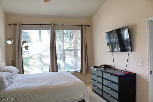 Bedroom with multiple windows and carpet | Image 15