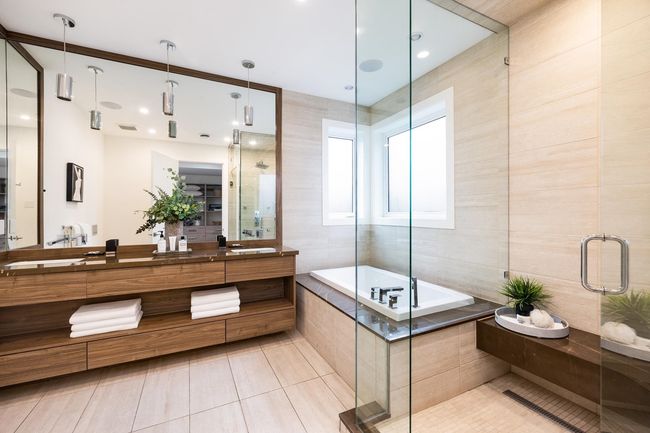 Full bath with vanity, a garden tub, a stall shower, tile patterned floors, and tile walls | Image 23