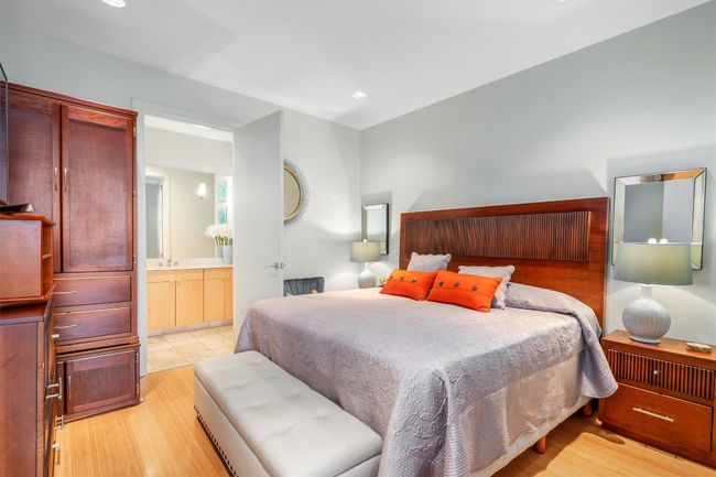 Bedroom with light wood finished floors and ensuite bath | Image 5