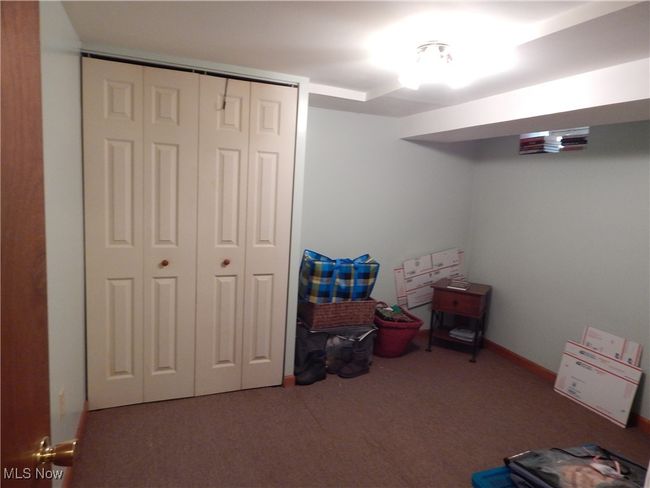 Basement Bedroom #4 with Carpeting and Double closet & Ceiling fan. Adjacent to Full bath in hall. | Image 26