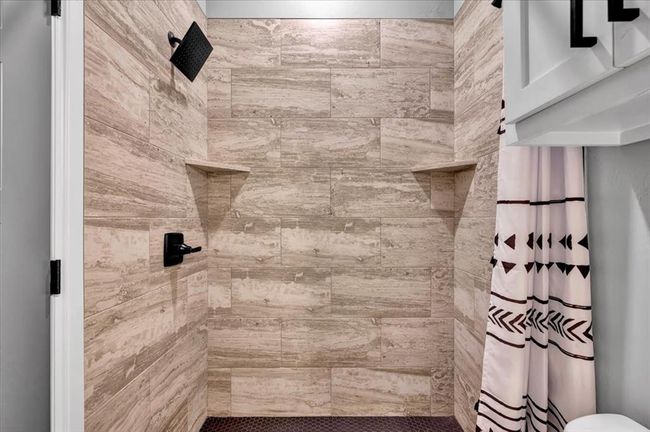 Bathroom featuring a tile shower | Image 40