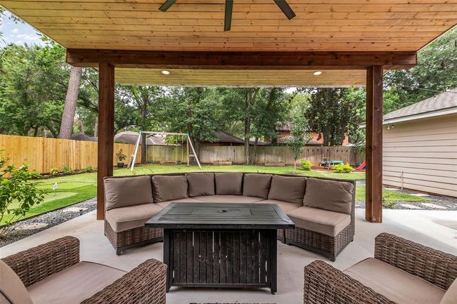 View from the extended covered patio into the backyard. | Image 36