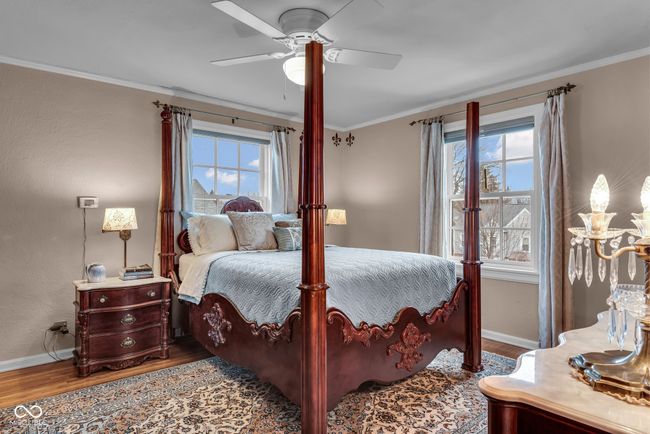 bedroom with baseboards, wood finished floors, and ornamental molding | Image 18