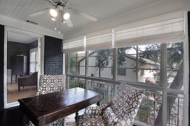 Sunroom with a ceiling fan and visible vents | Image 27