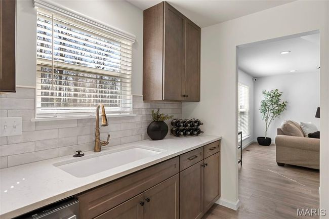Kitchen with a sink, decorative backsplash, dishwasher, light wood-type flooring, and recessed lighting | Image 10