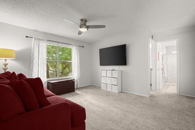 Bright and versatile, the game room upstairs is the perfect hangout spot, providing a spacious retreat where you can relax, play, or enjoy time with family and friends | Image 21