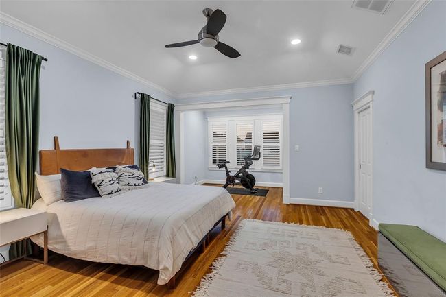 This spacious Primary suite is located on the second floor. It features hardwood floors, crown molding and a ceiling fan. It includes a cozy nook, which can be used as a reading nook or small exercise area. | Image 20