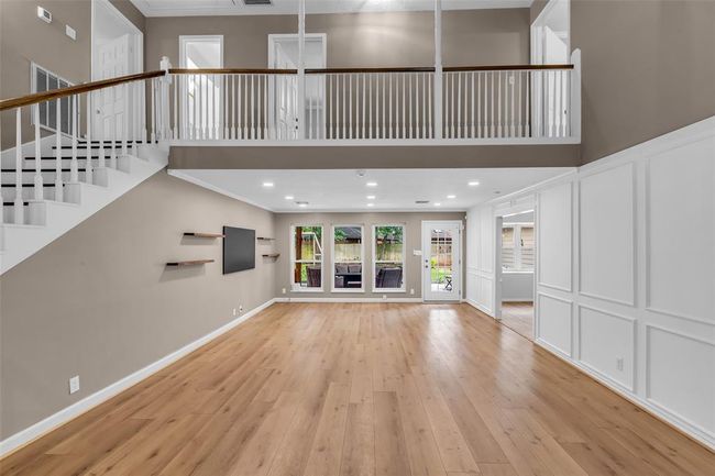The first level features an open-concept design with soaring ceilings that connect seamlessly to the second level. | Image 10