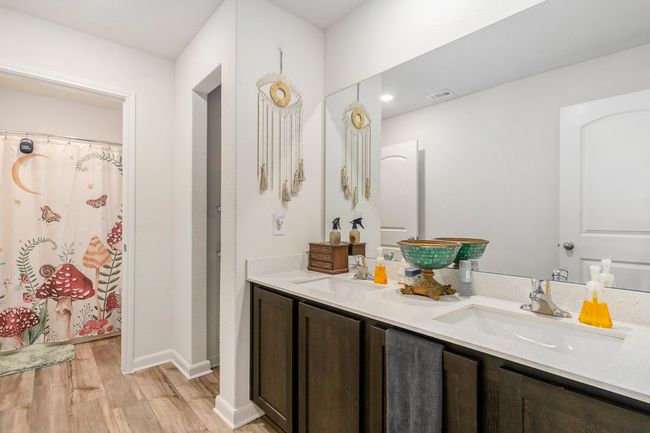 Bathroom with luxury vinyl plank floors, a sink, and double vanity. | Image 20